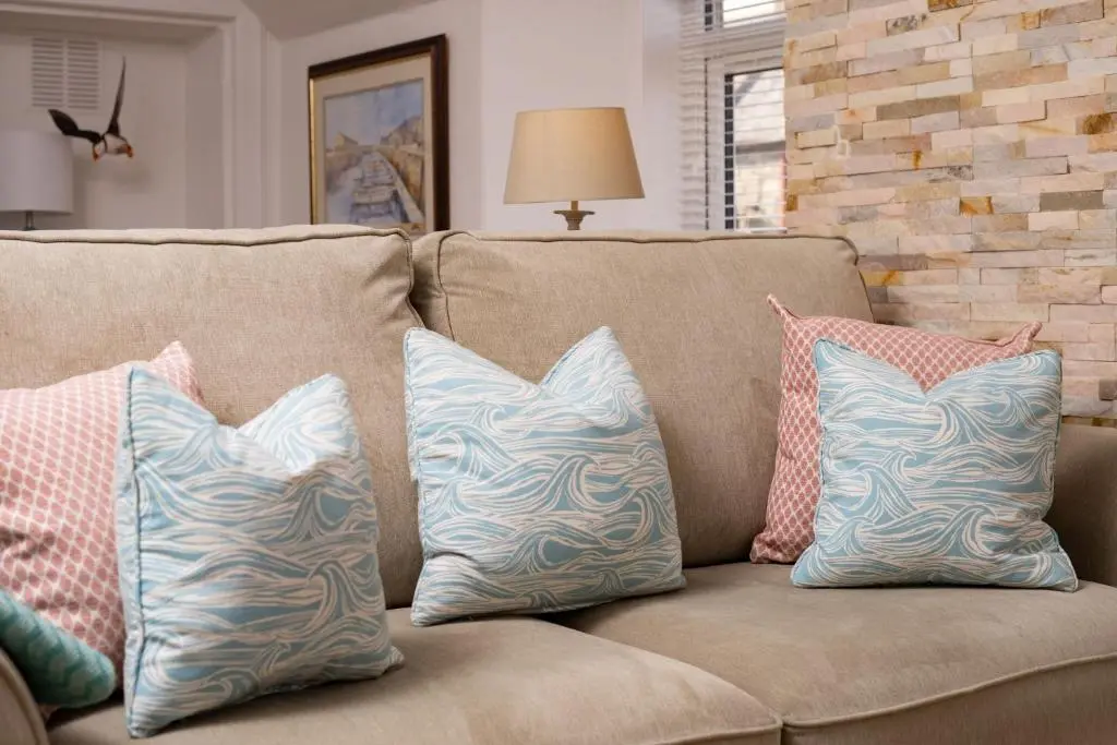 four pillows on a couch in a living room at Fishermans Rest in Lossiemouth