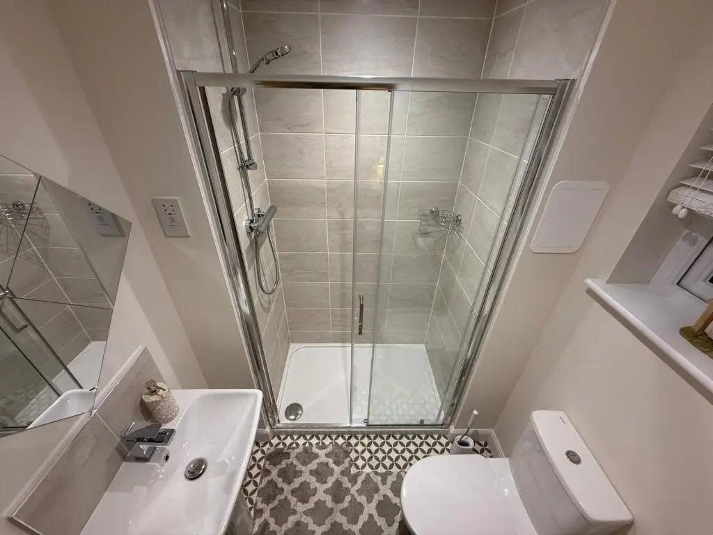 a bathroom with a shower and a toilet and a sink at Loch Ness Hideaway in Inverness