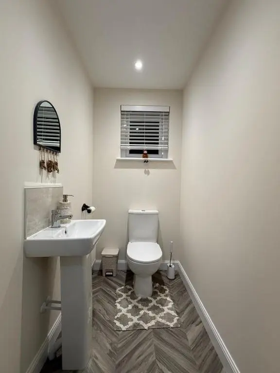 a bathroom with a white toilet and a sink at Loch Ness Hideaway in Inverness
