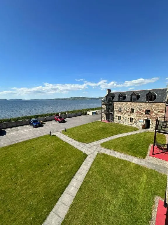 an aerial view of a building with a grass yard at Dolphin Bay Suites in Ardersier