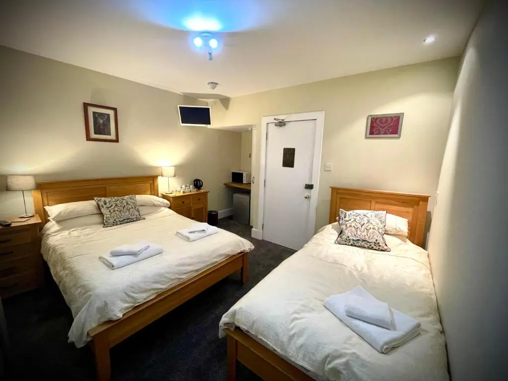 a bedroom with two beds with towels on them at Stag and Barrel in Elgin