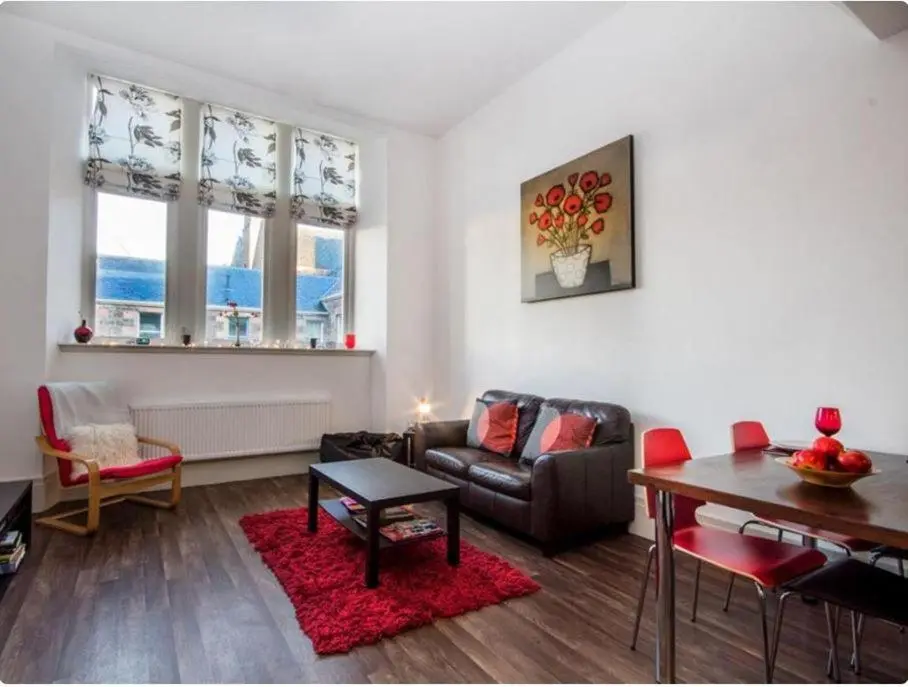 a living room with a couch and a table at Mercury Holiday Home 1 Bedroom 7 Westercraigs Apartment -Free Parking in Inverness