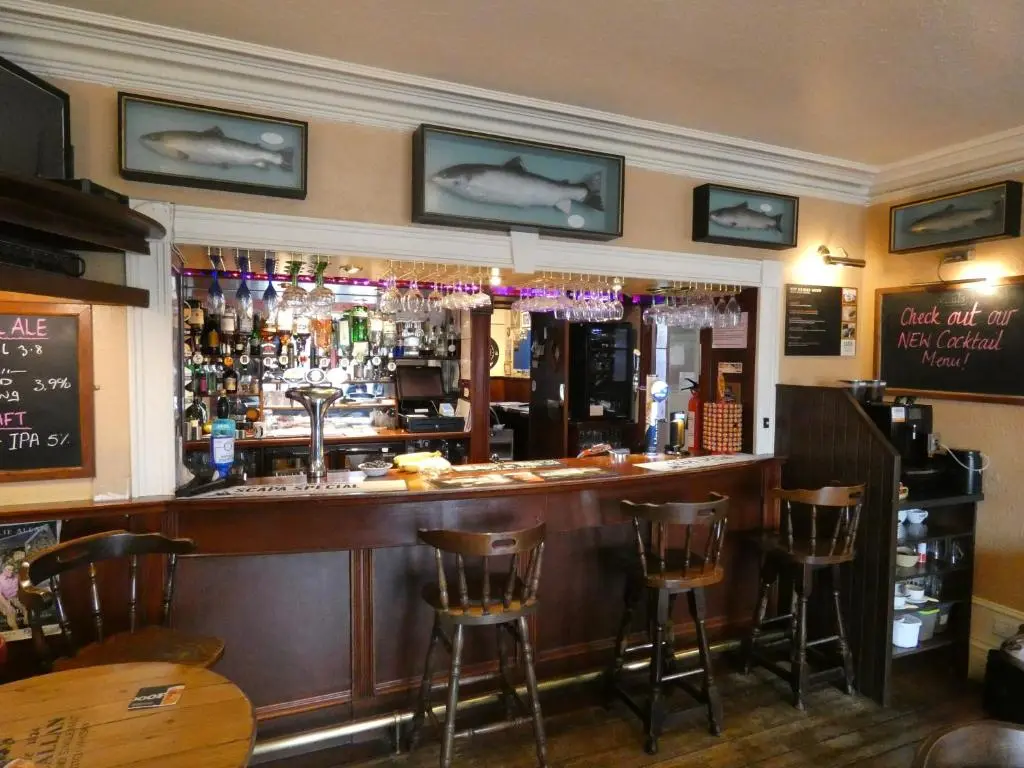 a bar with bar stools in a restaurant at Ythanview Hotel