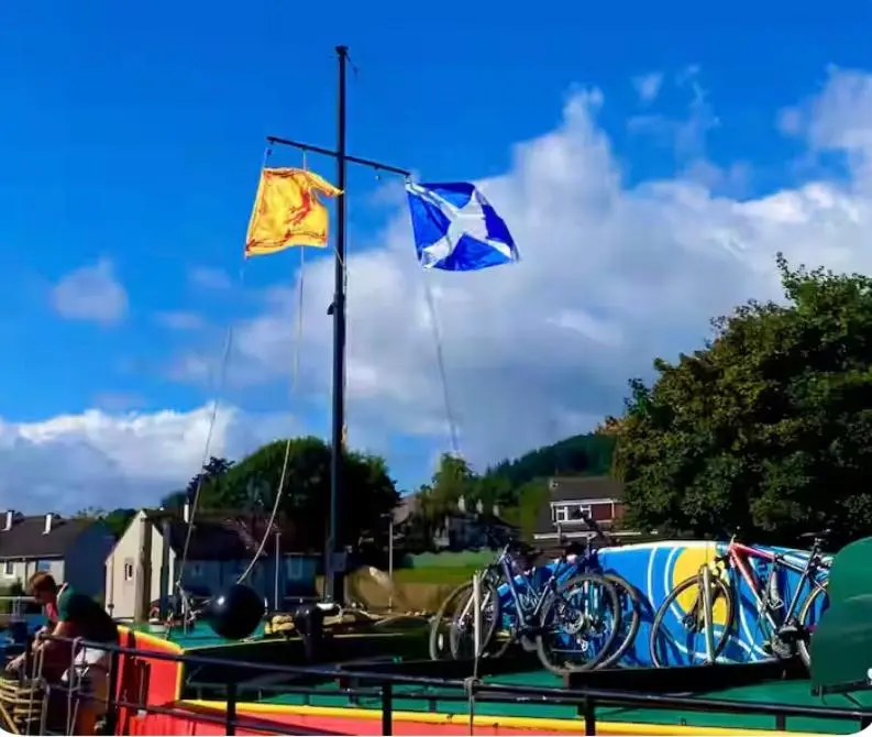 two flags on a table with bikes on it at Caledonian View House in Dalneigh