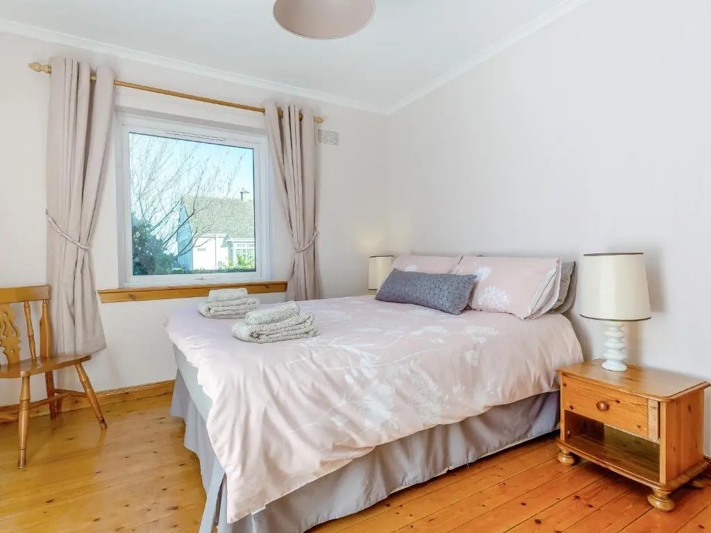 a bedroom with a bed and a window at The Cherry Tree in Cawdor