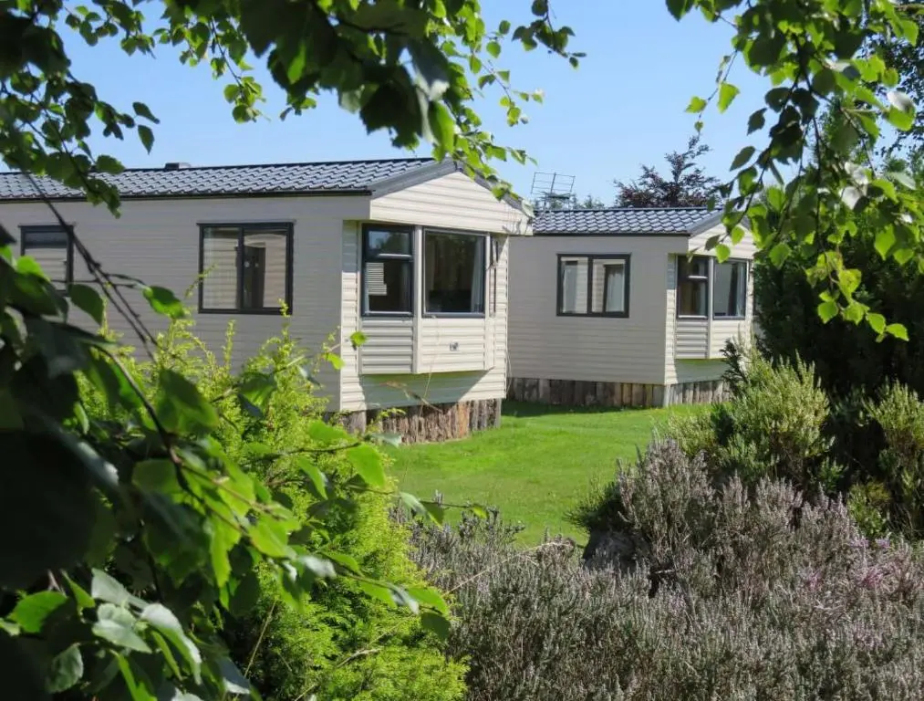 a house with a garden in front of it at Findhorn Bay - Mobile Holiday Homes in Findhorn
