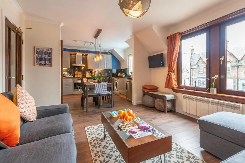 a living room with a couch and a table at An I\u00f9bhrach in Inverness