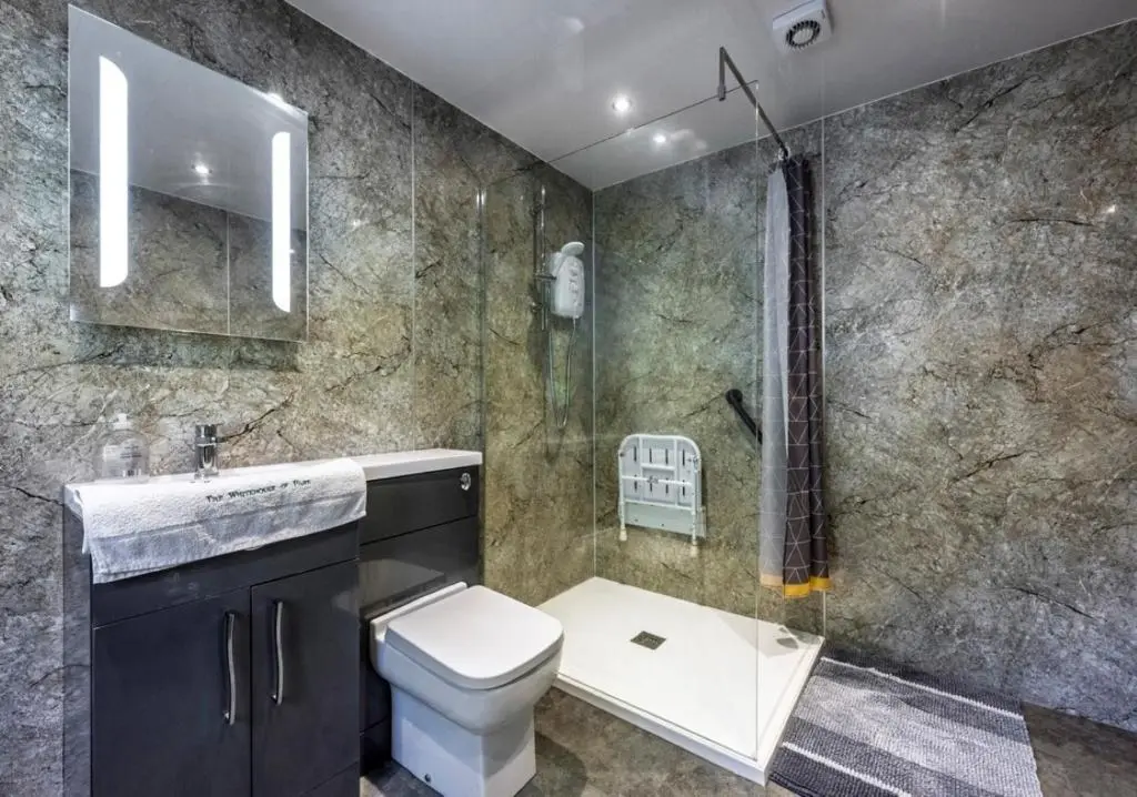 a bathroom with a toilet and a shower at Finest Retreats - White House Retreat in Cornhill