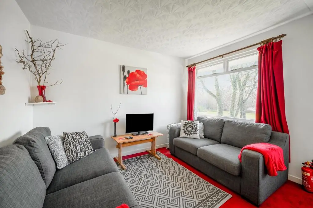 a living room with two couches and a television at 2 Bed Chalet - Sleeps 3 - River and mountain views in Strathpeffer
