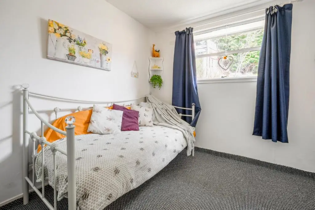 a bedroom with a bed and a window at 2 Bed Chalet - Sleeps 3 - River and mountain views in Strathpeffer
