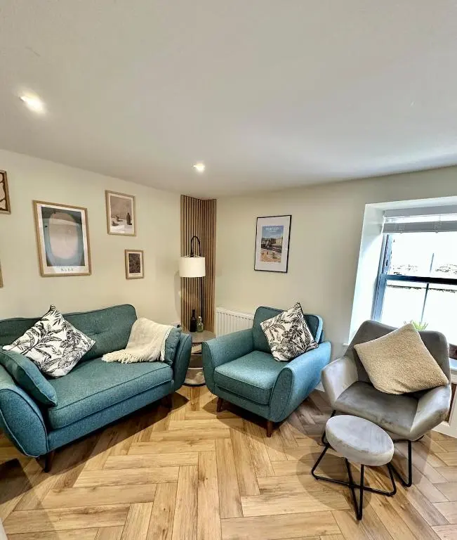 a living room with two couches and two chairs at Luxury Coastal Cottage in Portsoy