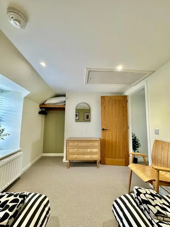 a living room with two beds and a window at Luxury Coastal Cottage in Portsoy
