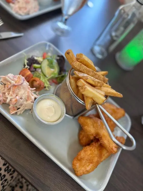 a plate of food with fried food and french fries at Luxury Coastal Cottage in Portsoy