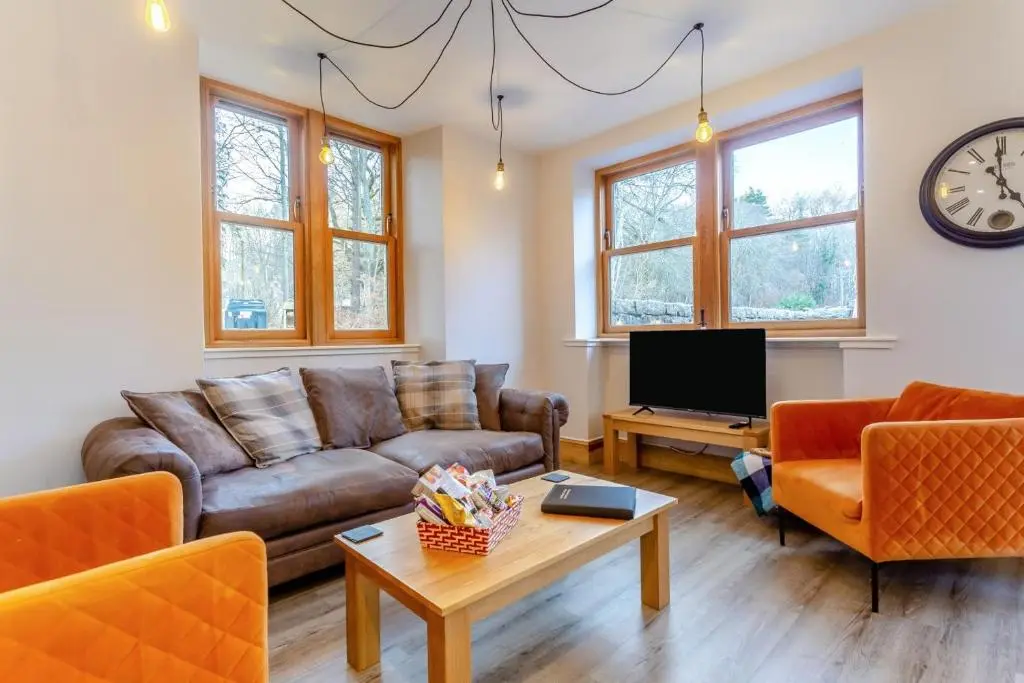 a living room with a couch and a tv at 3 Bed in Huntly oc-g31733 in Huntly