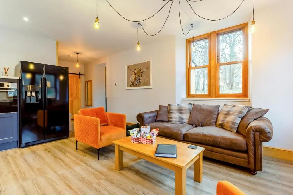 a living room with a couch and a table at 3 Bed in Huntly oc-g31733 in Huntly