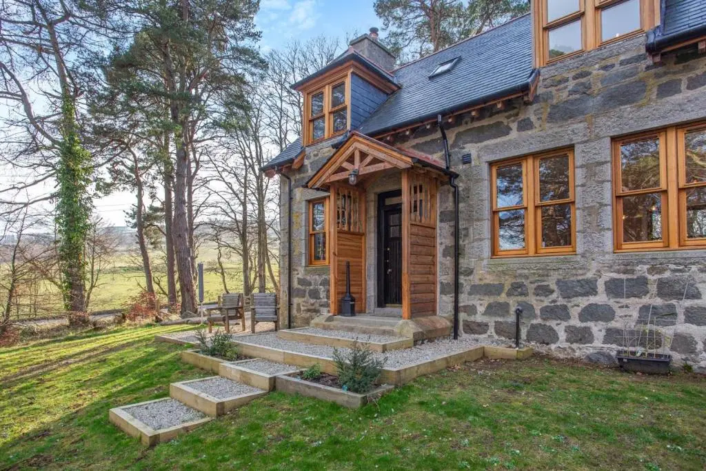 a stone house with a porch and stairs in the yard at 3 Bed in Huntly oc-g31733 in Huntly