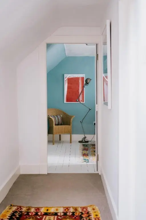 a hallway with a door open to a living room at Gamekeeper's Cottage in Banchory