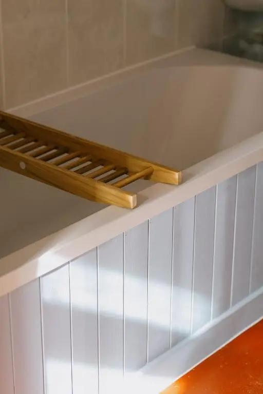 a white shelf with two wooden sticks on it at Gamekeeper's Cottage in Banchory