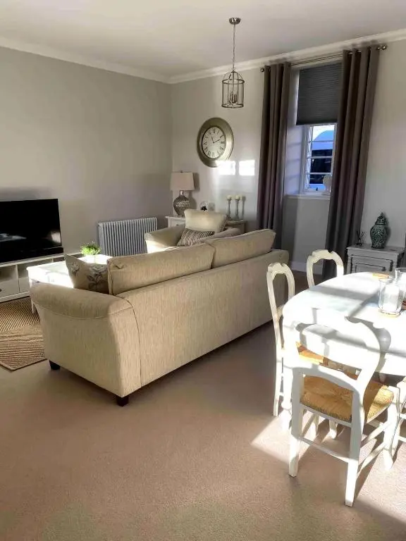 a living room with a couch and a table at 2 bedroom Townhouse within Grade C listed Ladysbridge House 2 night minimum stay in Ladysbridge Station