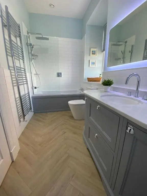 a bathroom with a sink and a shower and a toilet at 2 bedroom Townhouse within Grade C listed Ladysbridge House 2 night minimum stay in Ladysbridge Station