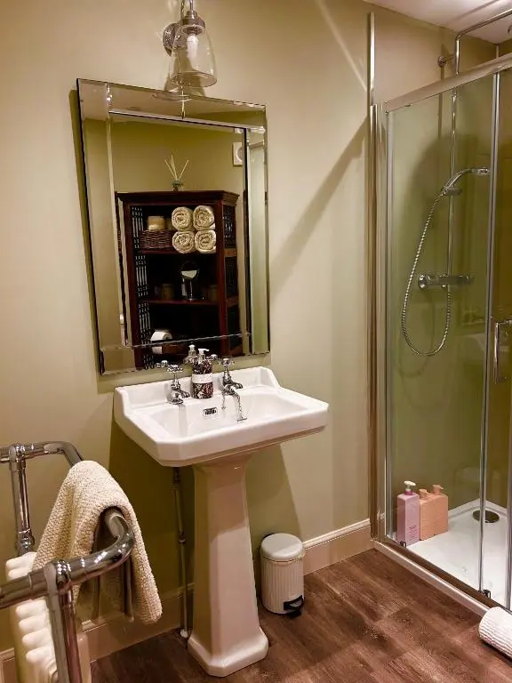 a bathroom with a sink and a shower at Clashmore House Garden Cottage Dornoch in Dornoch
