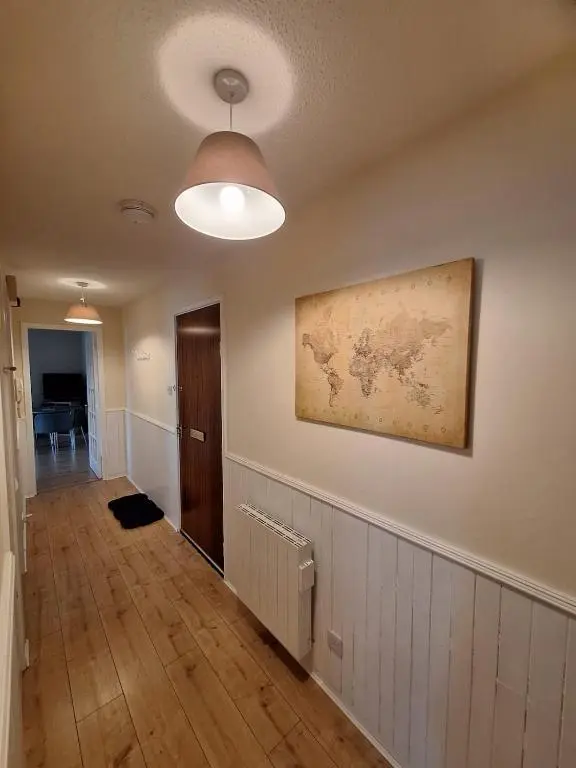 an empty room with a map on the wall at Inverness City Centre Apartment! in Inverness