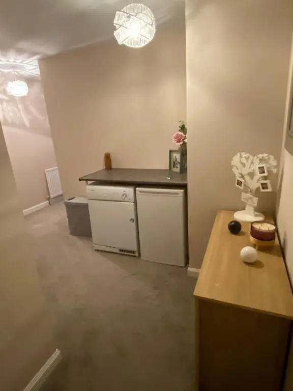 a small kitchen with a counter and a table at Impala Apartment in Wick