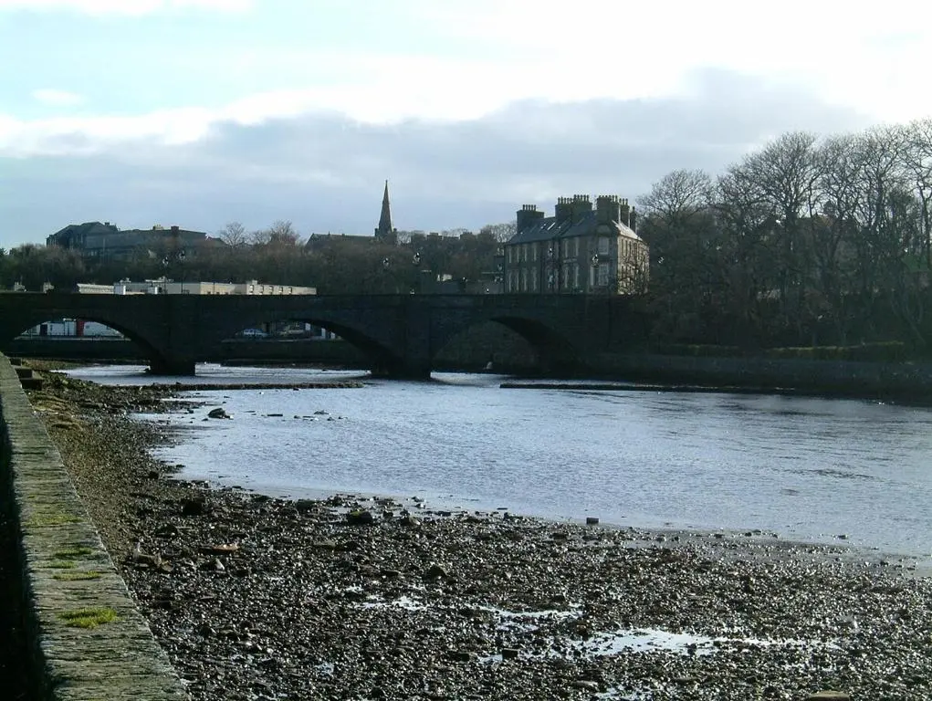 a bridge over a river in a city at Impala Apartment in Wick