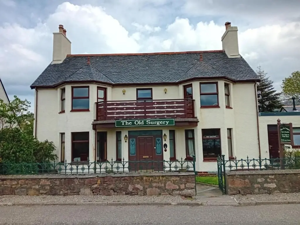 a building with a sign that reads its out surgery at Old Surgery Guest House in Ullapool