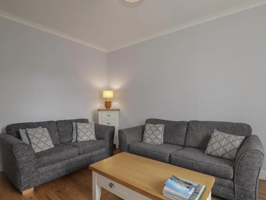 a living room with two couches and a coffee table at 6 New Street in Elgin