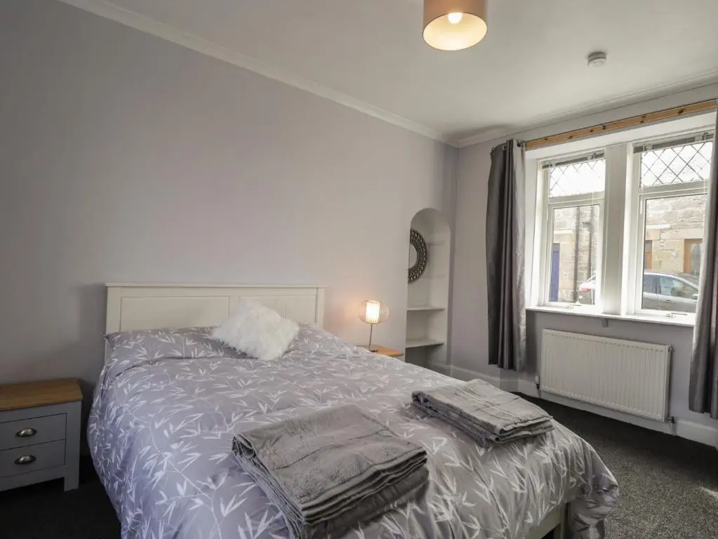 a bedroom with a bed and a window at 6 New Street in Elgin