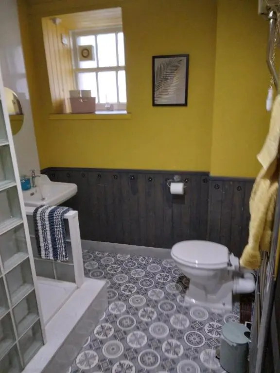 a bathroom with a toilet and a sink at Cosy central 2 bedroom apartment - free parking in Inverness