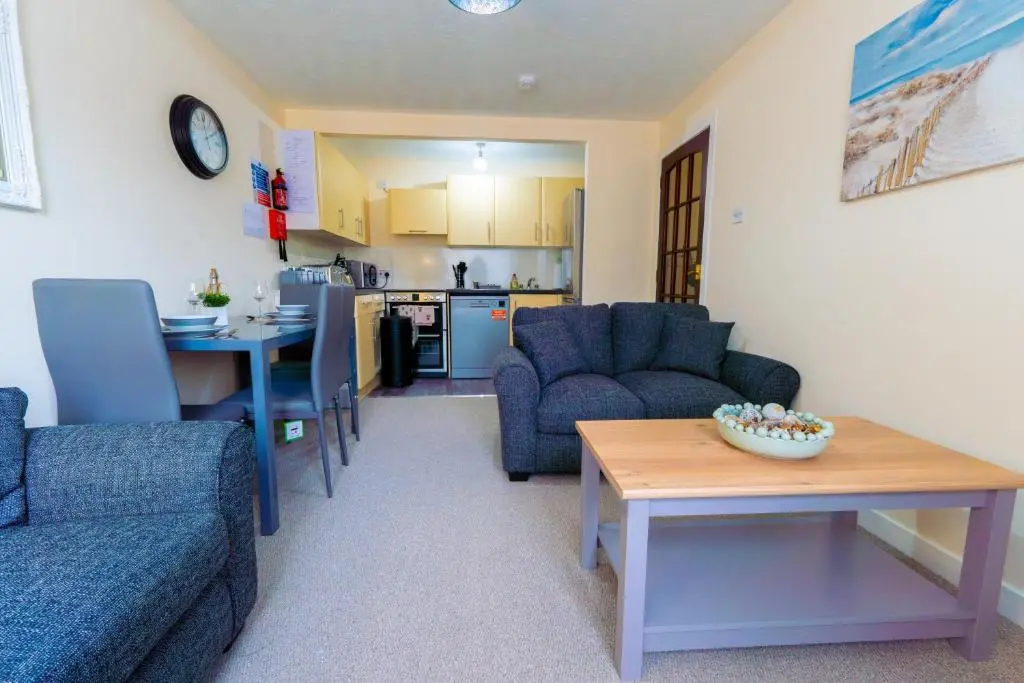 a living room with a couch and a table at Lovely & Bright 2 Bed Apartment in Inverness
