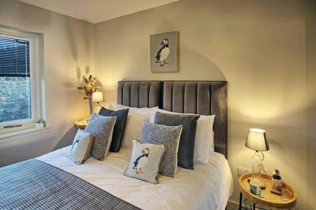 a bedroom with a king sized bed with pillows at Luxury Apartment Alford Aberdeenshire in Alford