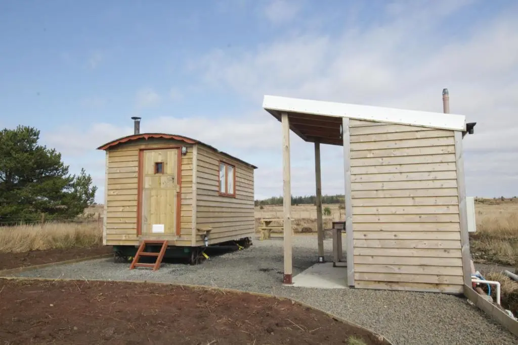 a small wooden building next to a shed at The Cairn Hut in Lybster