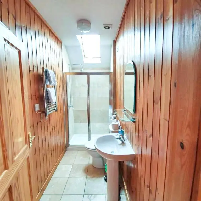 a bathroom with a sink and a toilet at The Bothy in Lumphanan