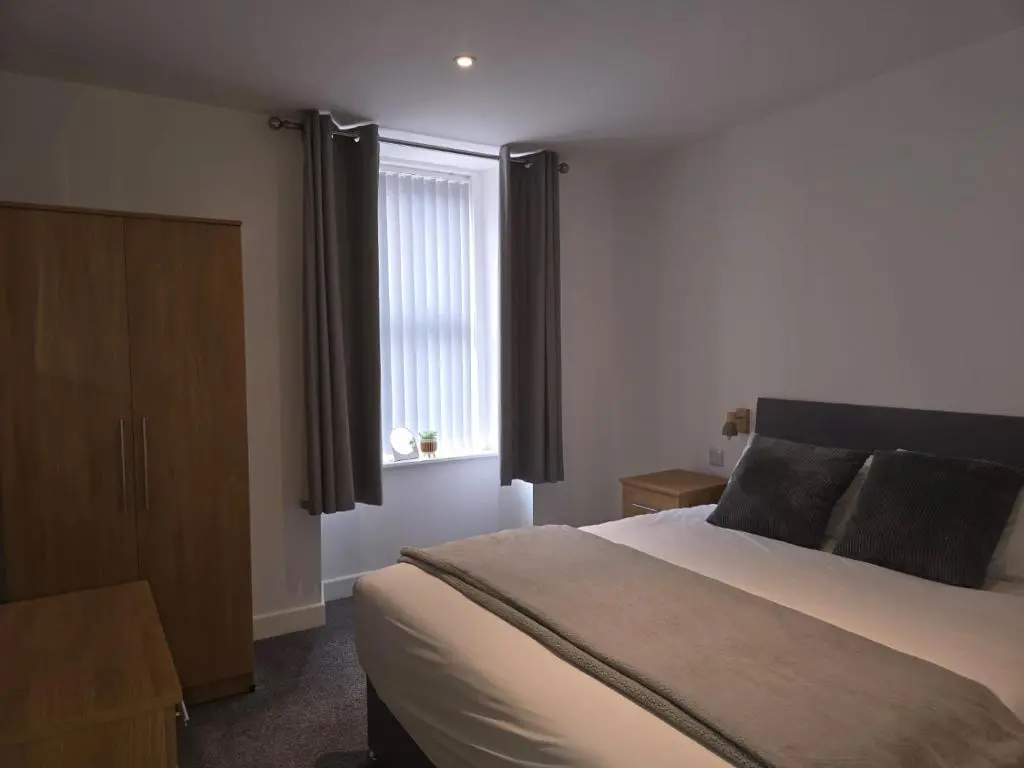 a bedroom with a large bed and a window at Nairn Nights in Nairn