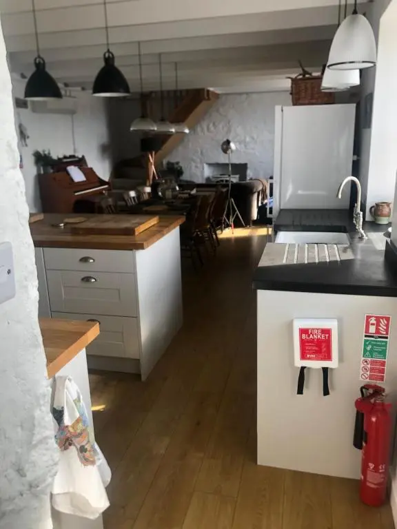 a kitchen with a counter with a stove top oven at The Hoose in Helmsdale