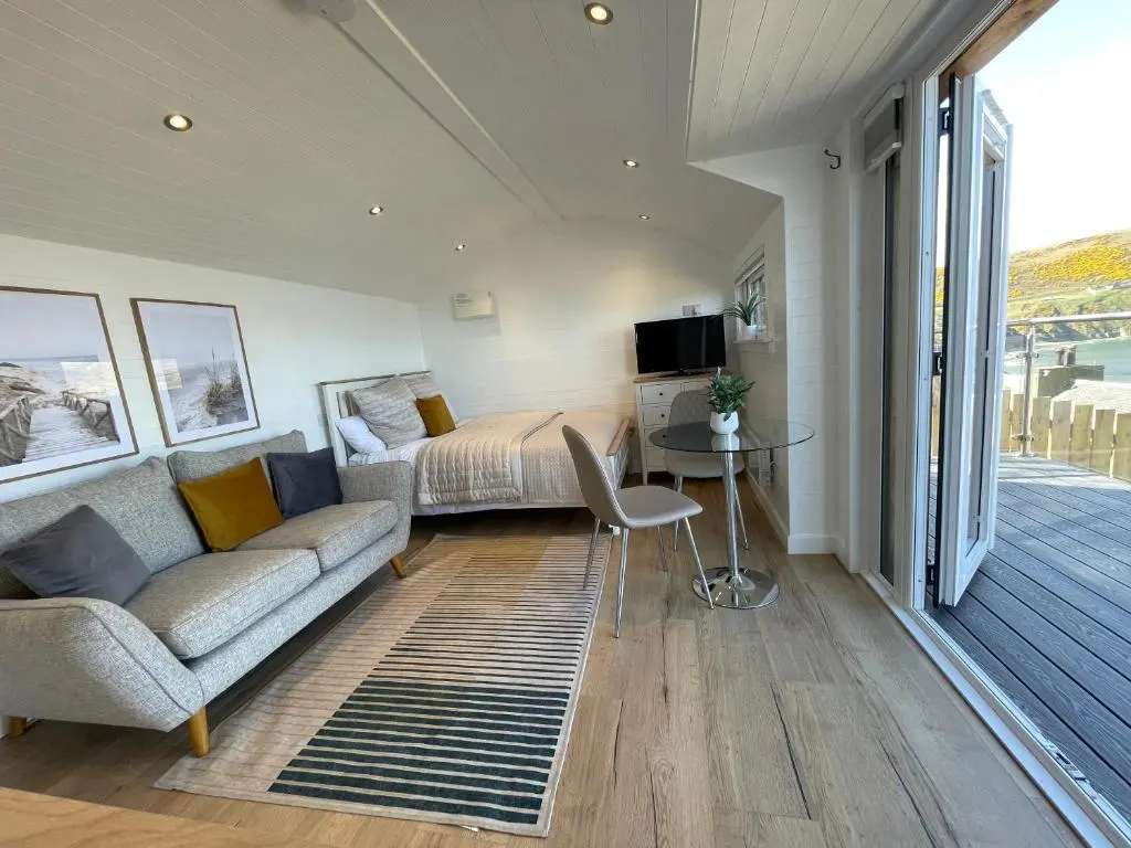 a living room with a couch and a bed at Gamrie Beach Bothy in Gardenstown