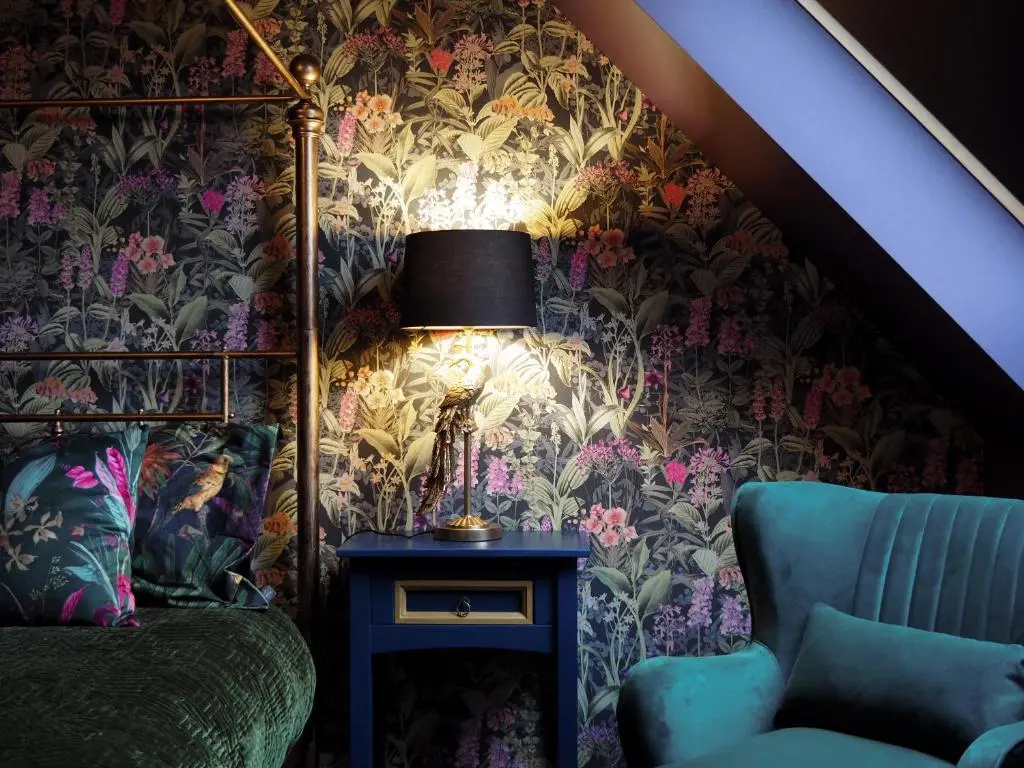 a bedroom with a bed and a table with a lamp at Old Manse of Craggan in Glenlivet