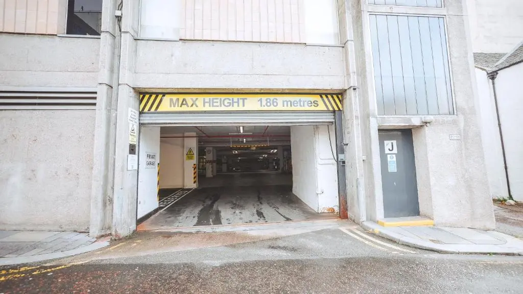 an empty parking garage with a sign that reads maxx light miles at St\u0101 by The Bridge, Inverness City Centre in Inverness