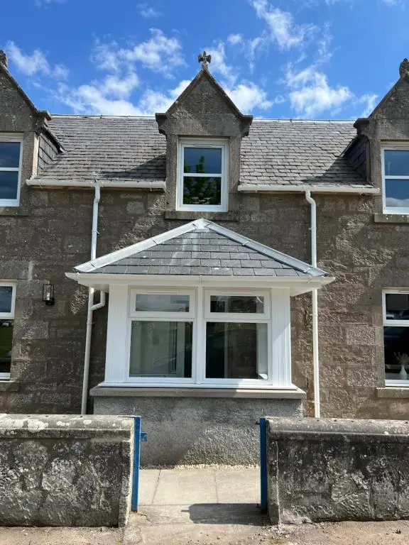 a house with a window and a roof at 2 Links Place in Nairn