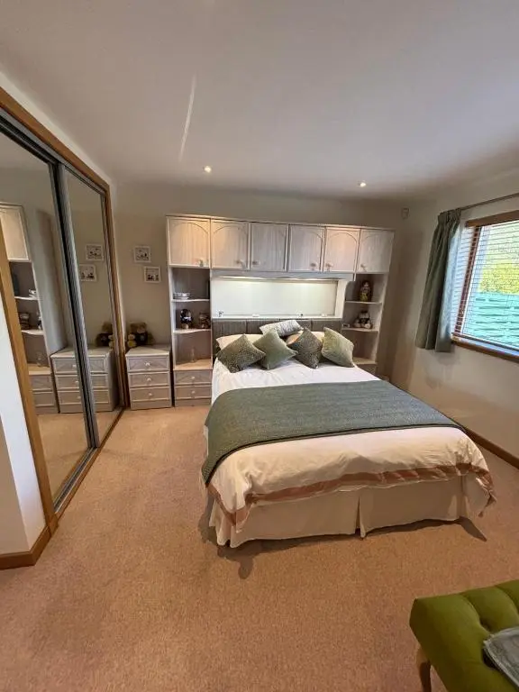 a bedroom with a large bed in a room at Danian B&B in Dingwall