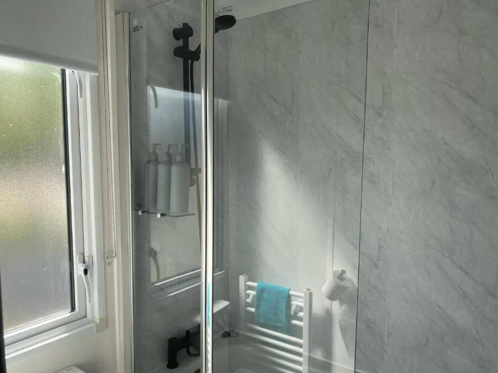 a shower in a bathroom with a glass door at Findhorn Lodge - Peaceful - Pets - Sleeps 4 in Forres
