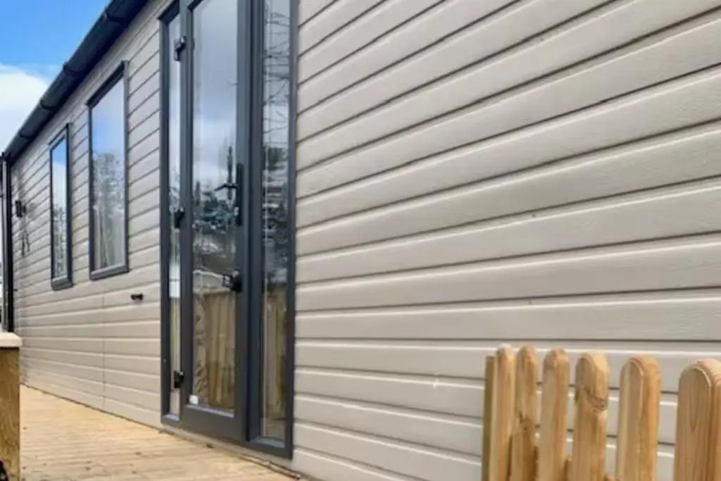 a sliding glass door on the side of a house at Findhorn Lodge - Peaceful - Pets - Sleeps 4 in Forres