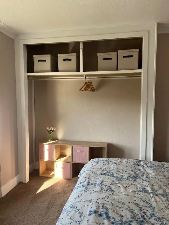 a bedroom with a bed and some shelves at Charlies in Huntly