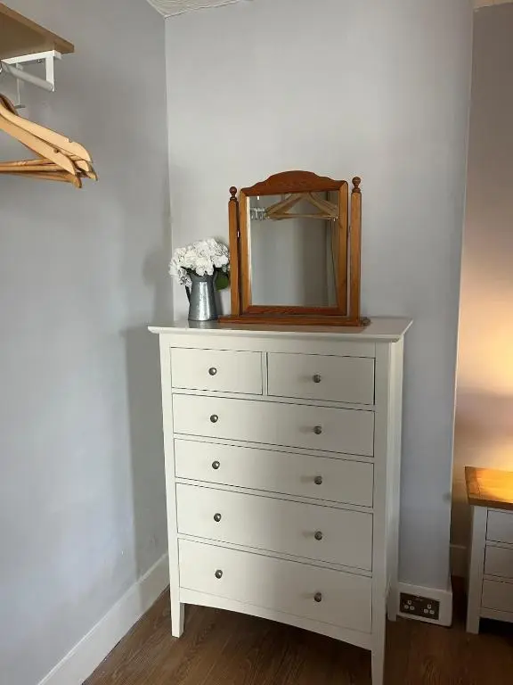 a dresser with a mirror on top of it at Charlies in Huntly