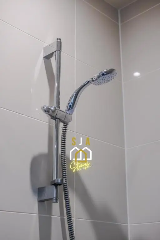 a shower with a shower head in a bathroom at Ballater Retreat - SJA Stays - Modern 1 Bed Apartment in Ballater