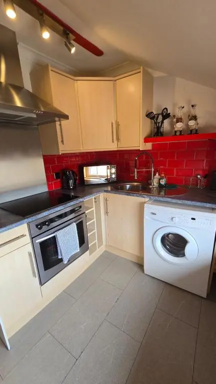 a kitchen with a washer and a washing machine at Stylish 1-Bed City Centre Flat in Inverness