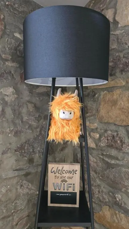 a lamp with a stuffed animal sitting on top of it at Stylish 1-Bed City Centre Flat in Inverness